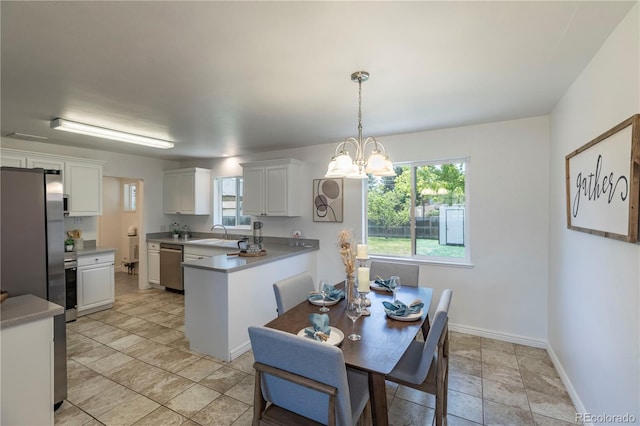 8800 W Kentucky Ave, Lakewood, CO 80226 - dining room with a chandelier and baseboards