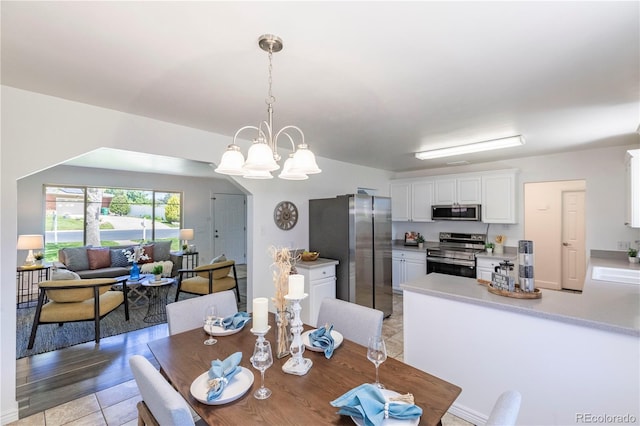 8800 W Kentucky Ave, Lakewood, CO 80226 - dining space with a chandelier and light tile patterned flooring