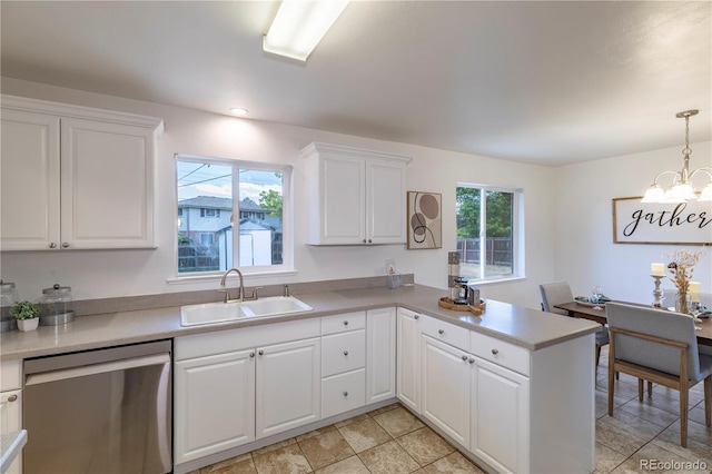 8800 W Kentucky Ave, Lakewood, CO 80226 - kitchen with stainless steel dishwasher, a sink, a chandelier, a peninsula, and light countertops