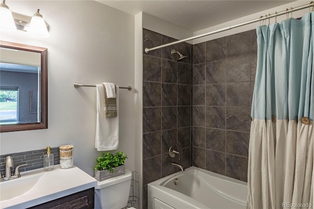 8800 W Kentucky Ave, Lakewood, CO 80226 - bathroom featuring shower / bath combo with shower curtain, vanity, toilet, and tasteful backsplash
