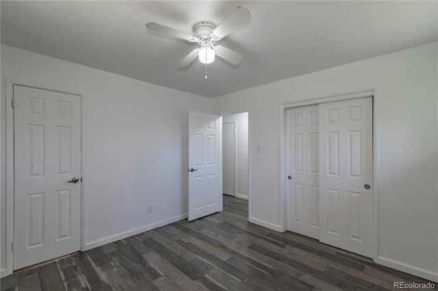 8800 W Kentucky Ave, Lakewood, CO 80226 - unfurnished bedroom with dark wood-type flooring, baseboards, a closet, and a ceiling fan