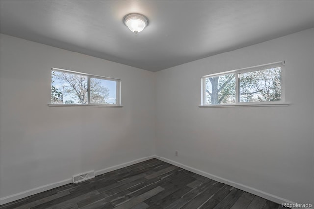 8800 W Kentucky Ave, Lakewood, CO 80226 - unfurnished room featuring baseboards and dark wood-style flooring