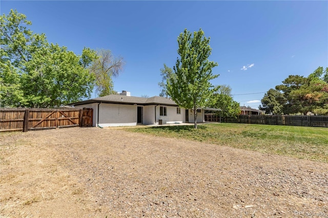 8800 W Kentucky Ave, Lakewood, CO 80226 - rear view of property with a patio area, stucco siding, a chimney, and a gate