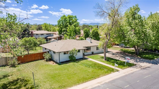 8800 W Kentucky Ave, Lakewood, CO 80226 - view of front of house with a shingled roof, a chimney, driveway, and stucco siding