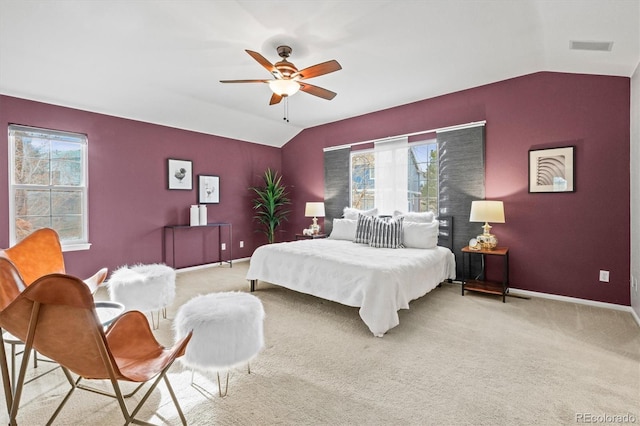 bedroom featuring a ceiling fan, vaulted ceiling, light colored carpet, and baseboards