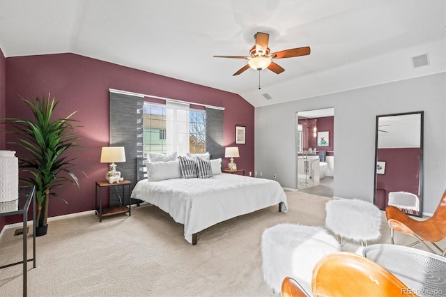 carpeted bedroom featuring visible vents, ceiling fan, baseboards, lofted ceiling, and ensuite bath