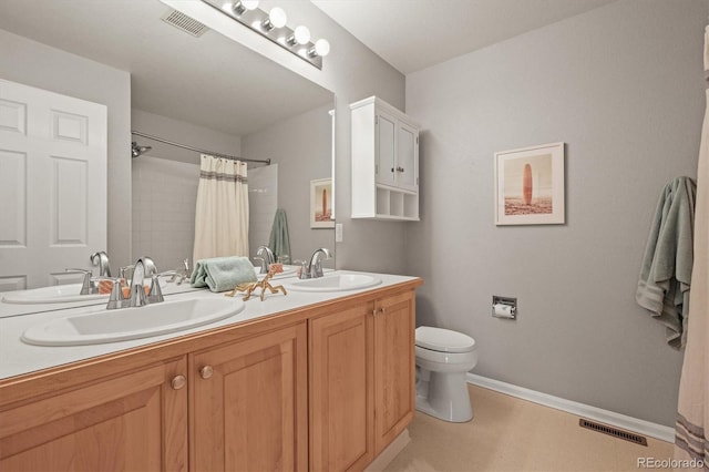 bathroom with a sink, visible vents, baseboards, and toilet