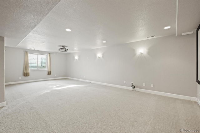 spare room with baseboards, visible vents, and light carpet