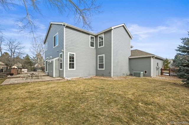 rear view of property featuring central AC unit, a lawn, a patio, and fence