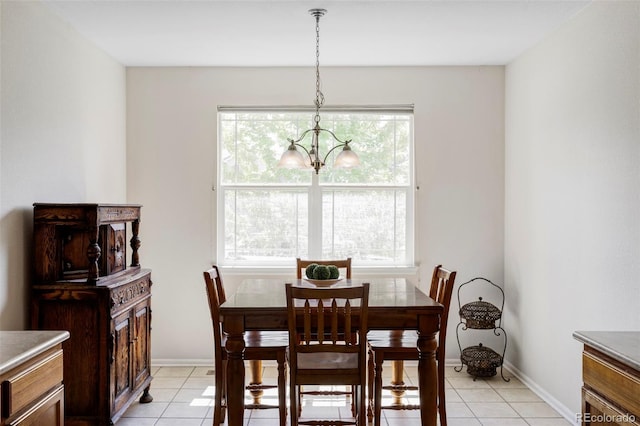 3972 S Shawnee Way, Aurora, CO 80018 - dining area with a chandelier, light tile patterned flooring, and baseboards