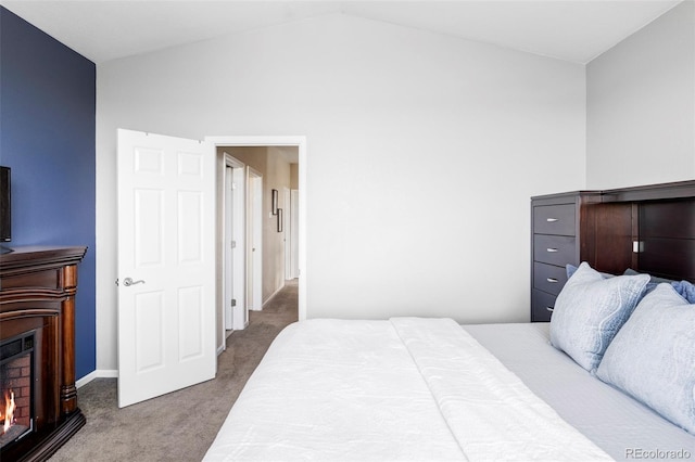 3972 S Shawnee Way, Aurora, CO 80018 - carpeted bedroom with a warm lit fireplace, vaulted ceiling, and baseboards