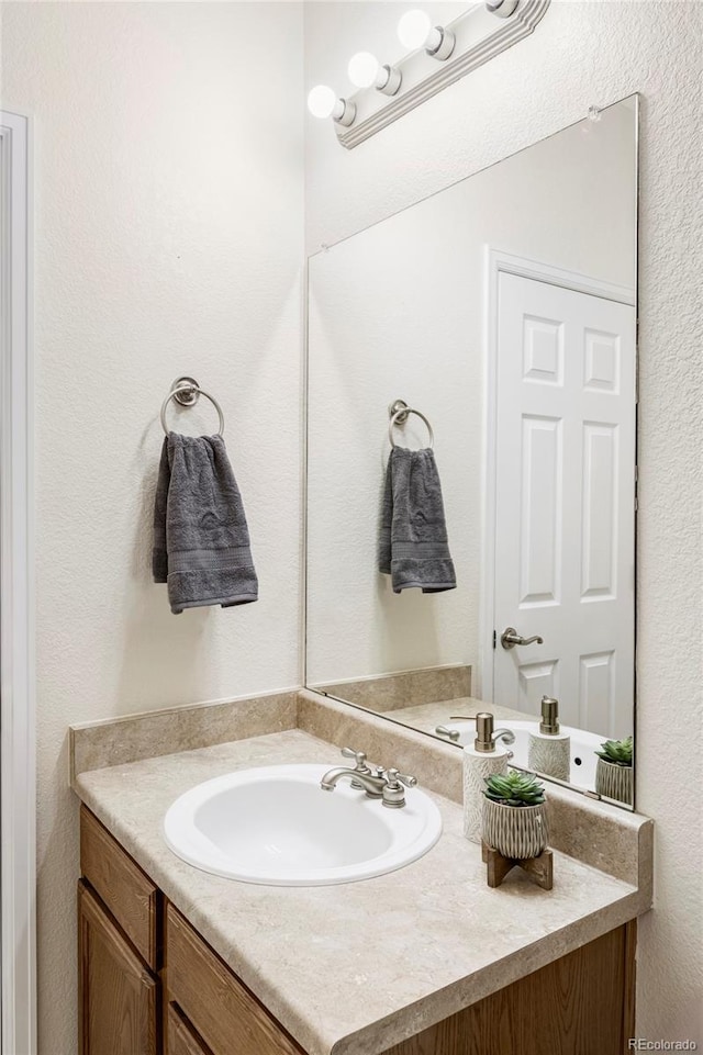 3972 S Shawnee Way, Aurora, CO 80018 - bathroom with vanity and a textured wall