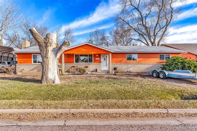 ranch-style house with a front yard and a carport