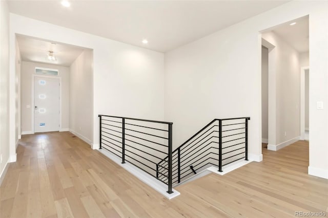 1711 Branching Canopy Dr, Windsor, CO 80550 - hall with an upstairs landing, wood finished floors, baseboards, and recessed lighting