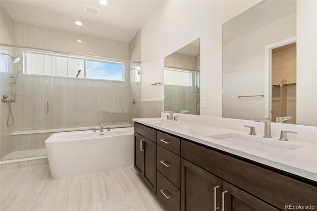 1711 Branching Canopy Dr, Windsor, CO 80550 - bathroom with a stall shower, a tub, and double vanity