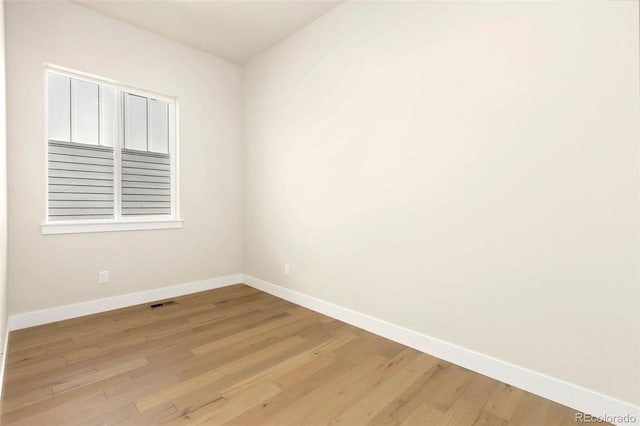 1711 Branching Canopy Dr, Windsor, CO 80550 - spare room featuring baseboards and light wood-type flooring