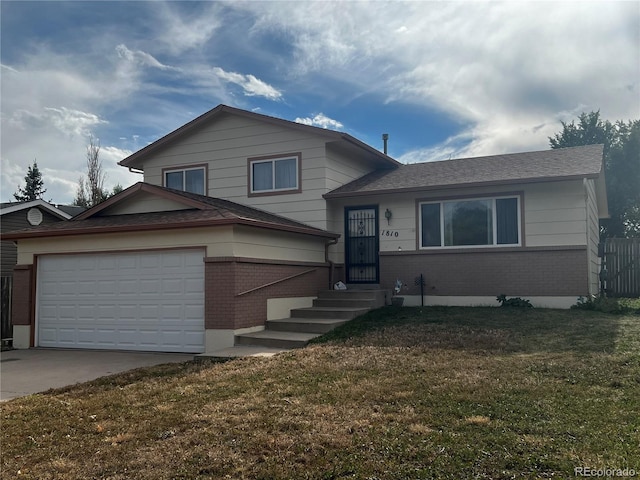 split level home featuring a garage and a front lawn