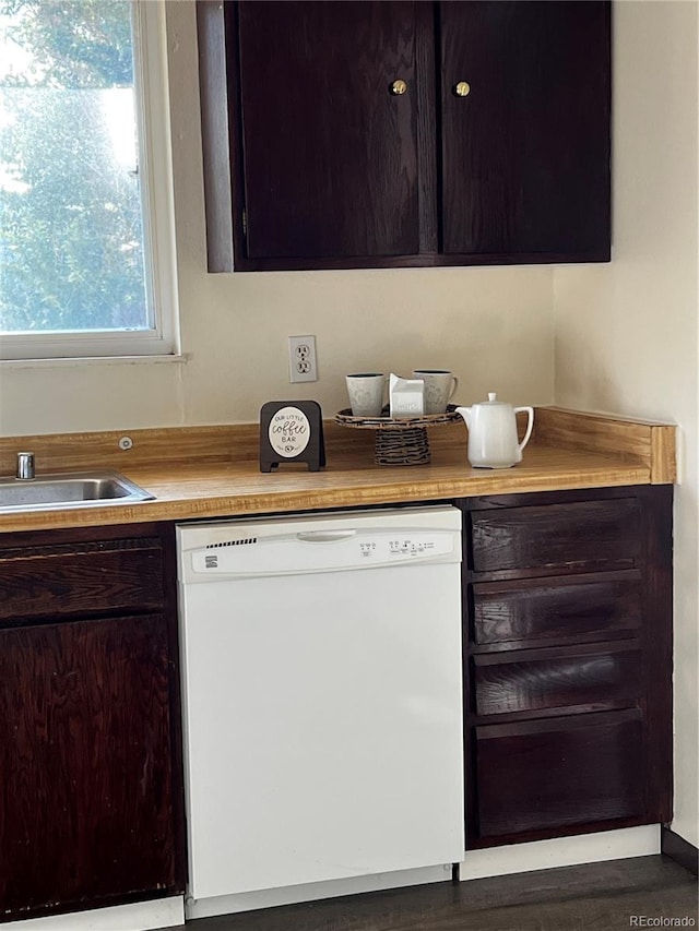 kitchen with wood-type flooring, sink, and white dishwasher