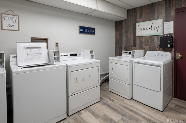 490 Kings Crossing Rd Unit 514, Winter Park, CO 80482 - community laundry room with separate washer and dryer, wooden walls, and light wood-style flooring