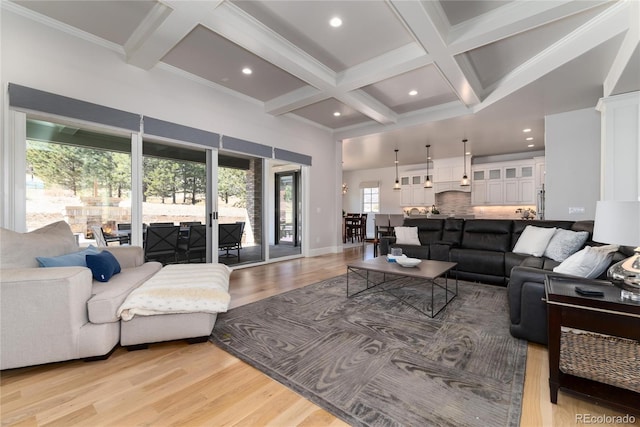 8033 Galileo Way, Littleton, CO 80125 - living area featuring coffered ceiling, beam ceiling, light wood finished floors, recessed lighting, and a towering ceiling