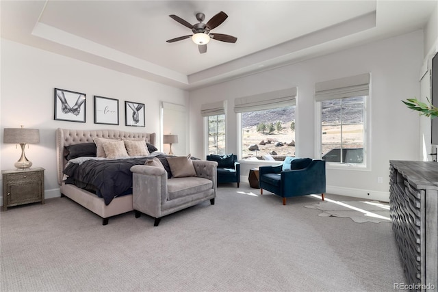 8033 Galileo Way, Littleton, CO 80125 - bedroom with light colored carpet, a tray ceiling, and baseboards