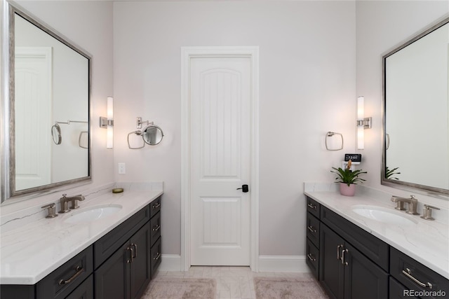 8033 Galileo Way, Littleton, CO 80125 - full bathroom featuring two vanities and baseboards