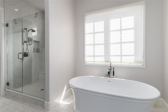 8033 Galileo Way, Littleton, CO 80125 - full bath featuring baseboards, a marble finish shower, and a freestanding tub