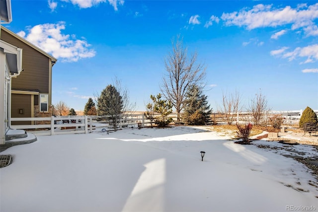 view of yard layered in snow