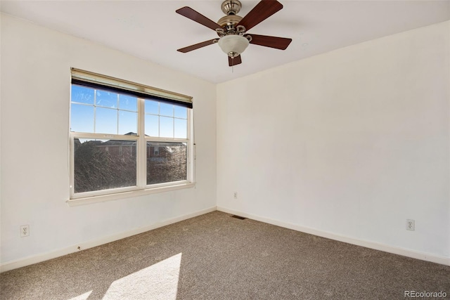 spare room featuring carpet floors and ceiling fan