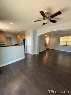 unfurnished living room with ceiling fan and dark hardwood / wood-style flooring