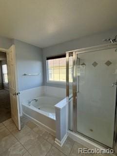 bathroom featuring plus walk in shower and tile patterned flooring