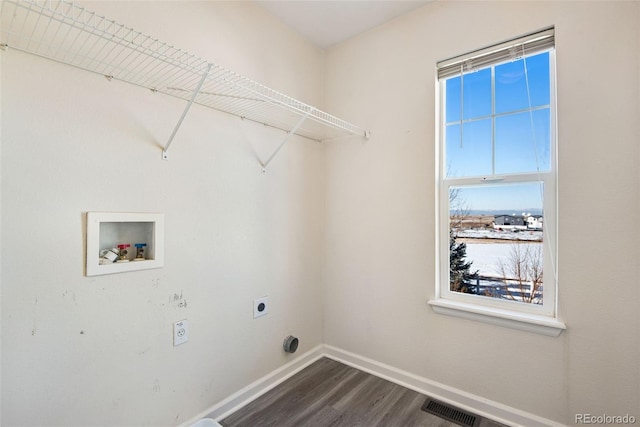 clothes washing area featuring a wealth of natural light, hookup for a washing machine, hardwood / wood-style floors, and electric dryer hookup