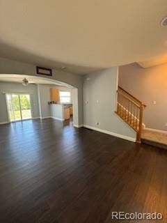 unfurnished living room featuring dark hardwood / wood-style flooring