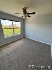 carpeted empty room featuring ceiling fan