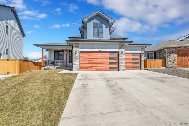 804 Spyglass Cir, Louisville, CO 80027 - contemporary house with a front lawn, board and batten siding, fence, and covered porch
