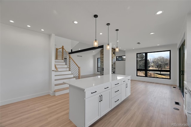 804 Spyglass Cir, Louisville, CO 80027 - kitchen featuring recessed lighting, a kitchen island, light wood-type flooring, and white cabinetry