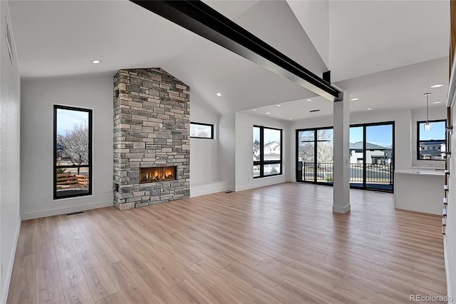 804 Spyglass Cir, Louisville, CO 80027 - unfurnished living room with light wood-style floors, baseboards, a stone fireplace, and visible vents