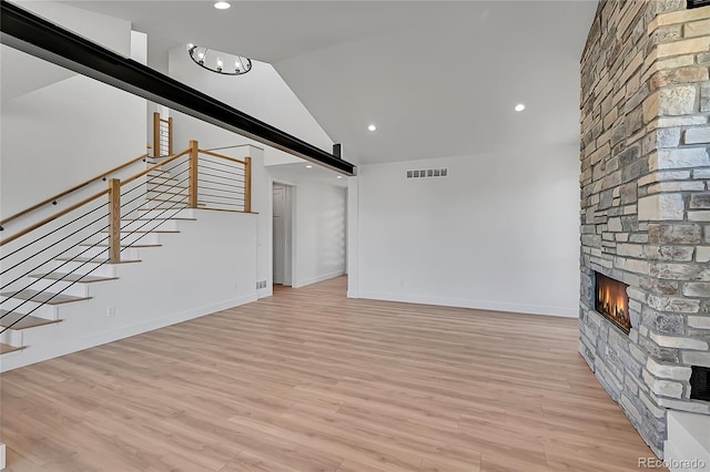 804 Spyglass Cir, Louisville, CO 80027 - unfurnished living room with visible vents, stairs, lofted ceiling, a fireplace, and baseboards