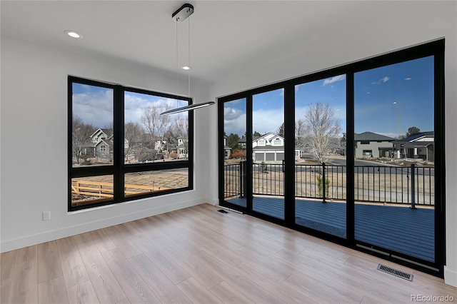 804 Spyglass Cir, Louisville, CO 80027 - empty room featuring baseboards, a wealth of natural light, wood finished floors, and visible vents