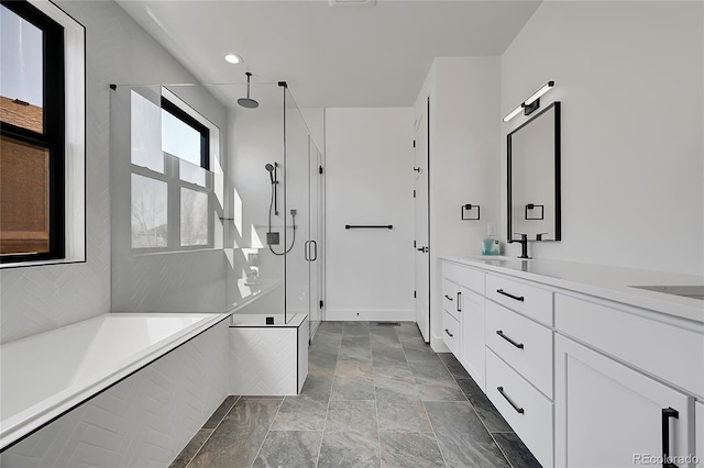 804 Spyglass Cir, Louisville, CO 80027 - full bathroom with stone finish floor, a garden tub, a stall shower, vanity, and recessed lighting