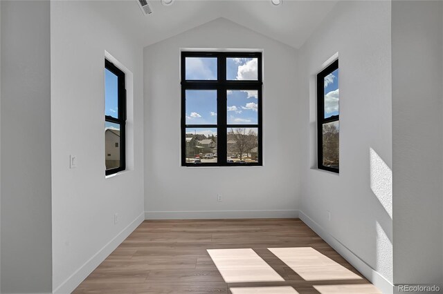 804 Spyglass Cir, Louisville, CO 80027 - spare room with light wood-style floors, baseboards, lofted ceiling, and visible vents