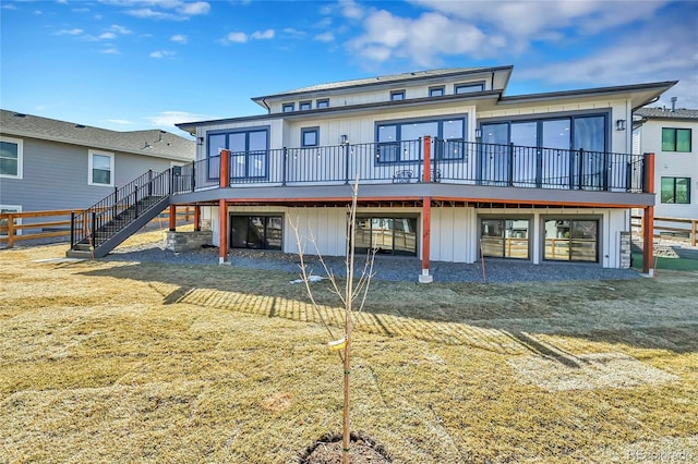 804 Spyglass Cir, Louisville, CO 80027 - rear view of property with a wooden deck, board and batten siding, a yard, and stairway