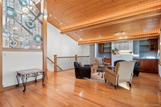 living room with wood ceiling, light hardwood / wood-style floors, and lofted ceiling with beams