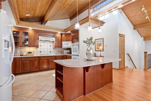 kitchen with tasteful backsplash, wooden ceiling, a kitchen island, pendant lighting, and white appliances