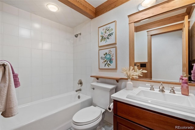 full bathroom featuring vanity, tiled shower / bath combo, and toilet