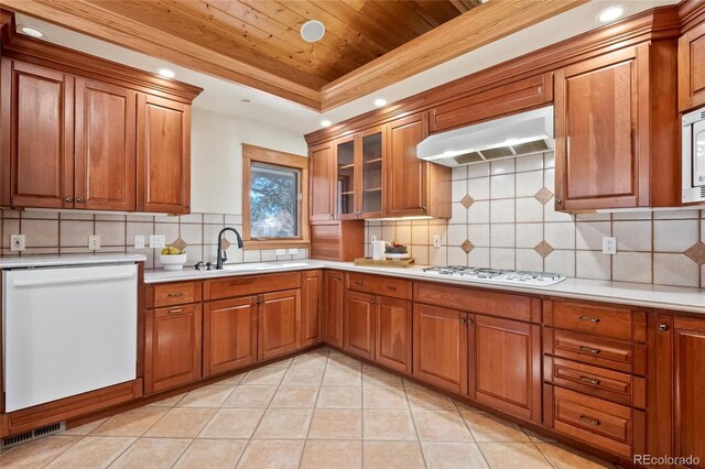 kitchen featuring sink, ventilation hood, wooden ceiling, a raised ceiling, and white appliances