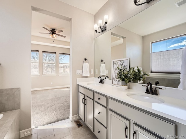 full bathroom featuring a sink, visible vents, double vanity, and tile patterned floors