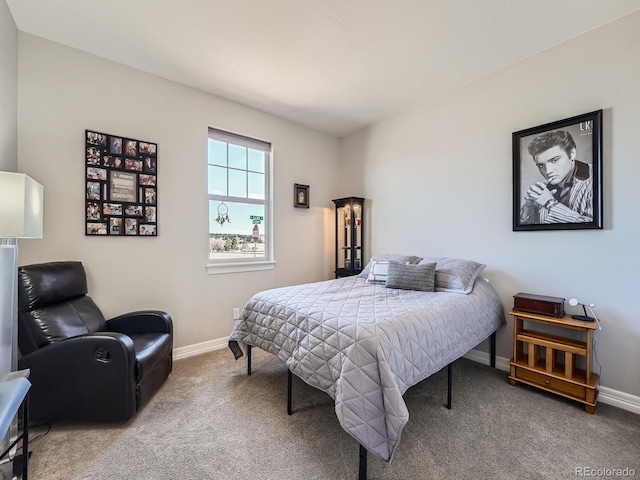 carpeted bedroom featuring baseboards