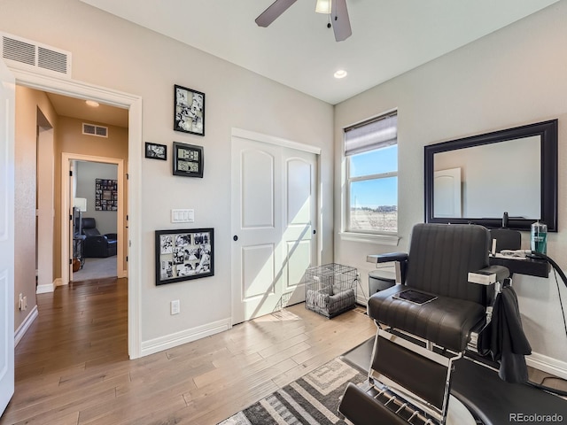 office featuring a ceiling fan, wood finished floors, visible vents, and baseboards