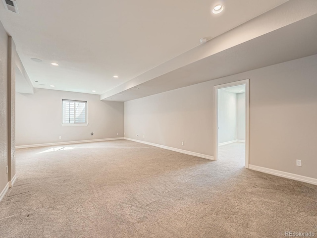 carpeted spare room featuring visible vents, recessed lighting, and baseboards